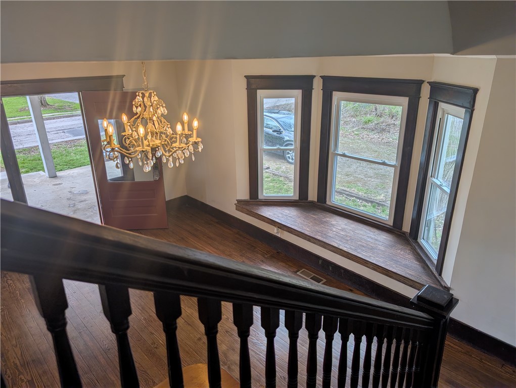 10796 Preble County Line Road Brookville, OH 45309 - Photo 16 of 33 This entry features rich wood floors, an ornate chandelier, and large windows that flood the space with natural light.