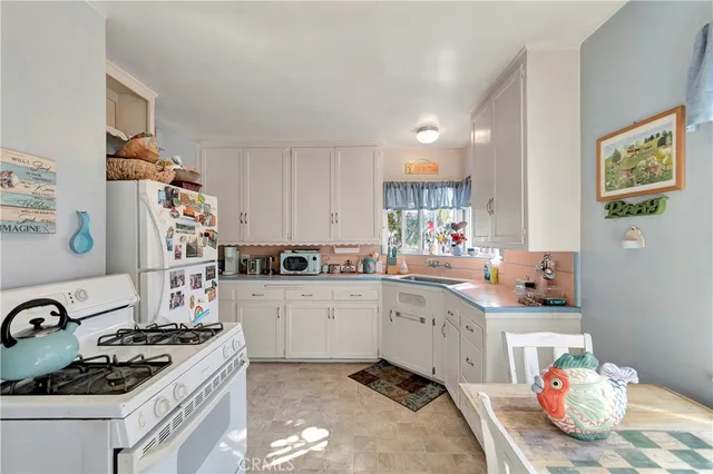 a kitchen with cabinets and a stove top oven
