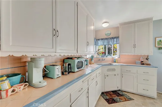 a kitchen with stainless steel appliances kitchen island granite countertop a sink and cabinets