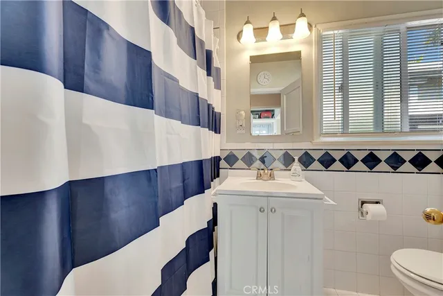 an outdoor space with patio lots of white furniture and umbrella