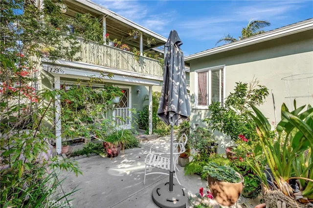 a large white kitchen with stainless steel appliances granite countertop a stove and a refrigerator