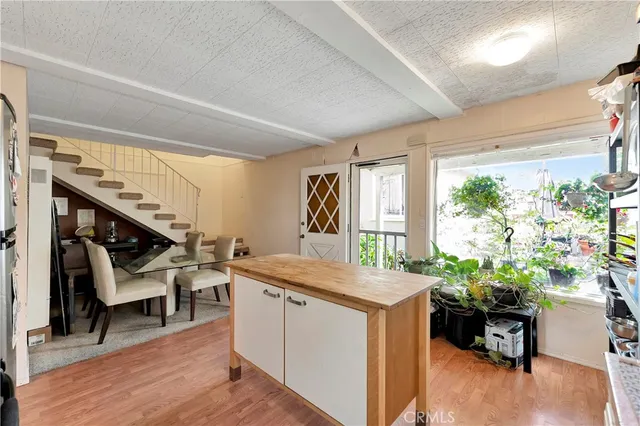 a large kitchen with cabinets wooden floor and stainless steel appliances