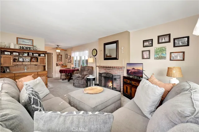 a living room with furniture a fireplace and a flat screen tv