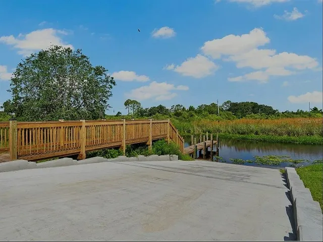 a view of a street with a wooden fence