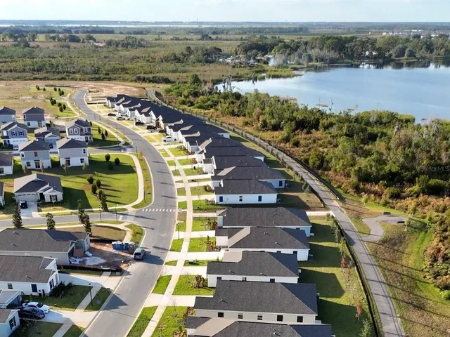 an aerial view of a house with a lake view