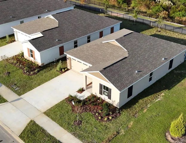 an aerial view of a house with a yard