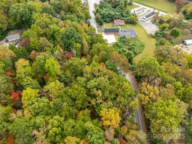 an aerial view of residential houses with yard