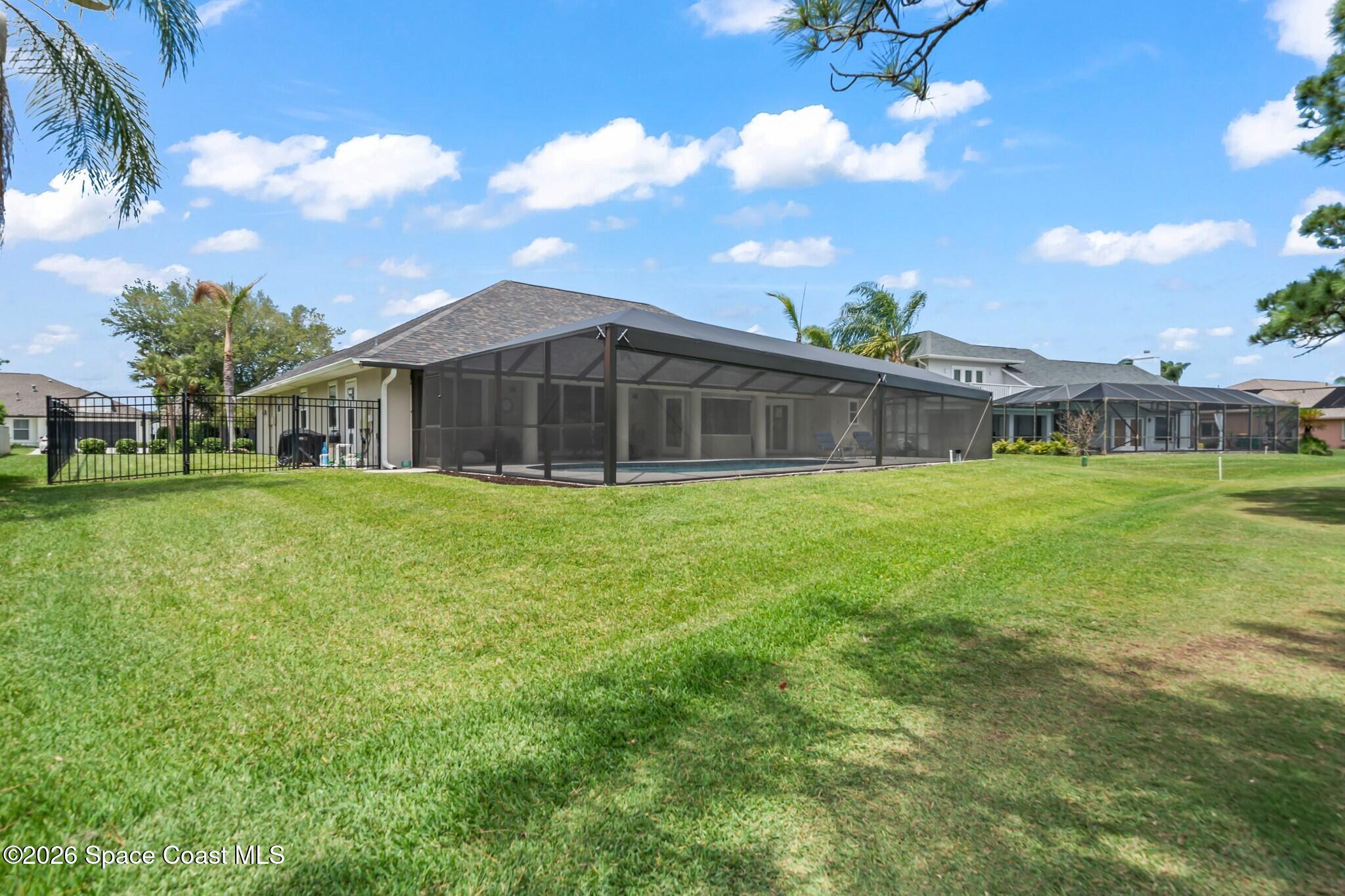 697 Spring Lake Drive Melbourne, FL 32940 - Photo 35 of 45 a view of a house with a yard
