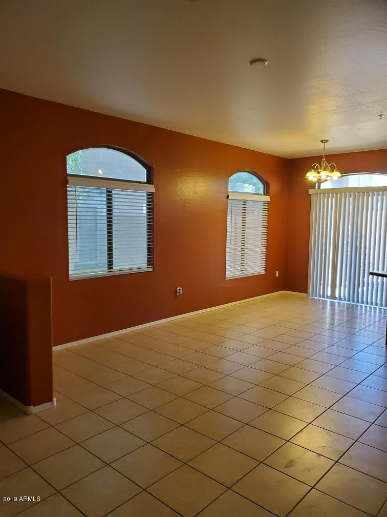 17365 North Cave Creek Road, Unit 114 Phoenix, AZ 85032 - Photo 3 of 18 a view of empty room with wooden floor