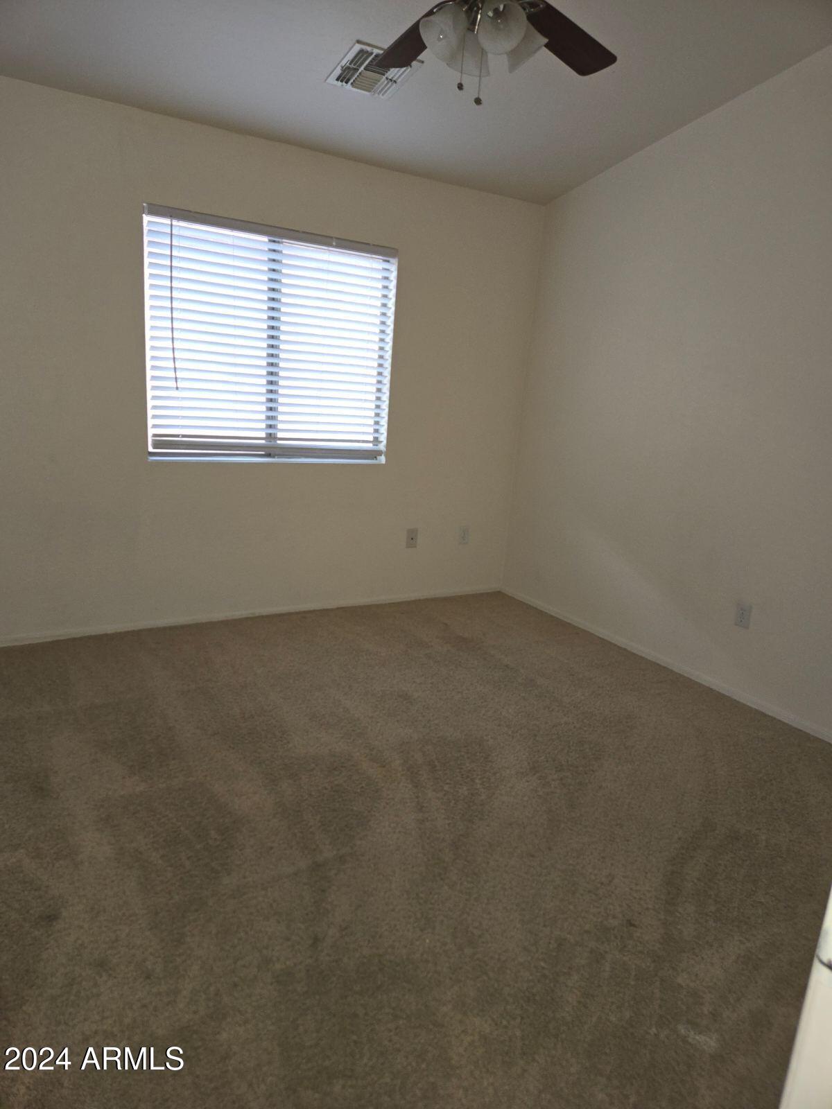 17365 North Cave Creek Road, Unit 114 Phoenix, AZ 85032 - Photo 9 of 18 an empty room with a window