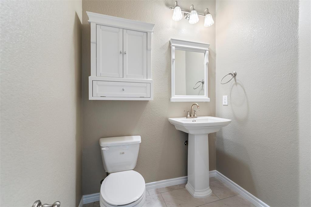 500 Braewick Drive Fort Worth, TX 76131 - Photo 14 of 35 a bathroom with a toilet sink and mirror