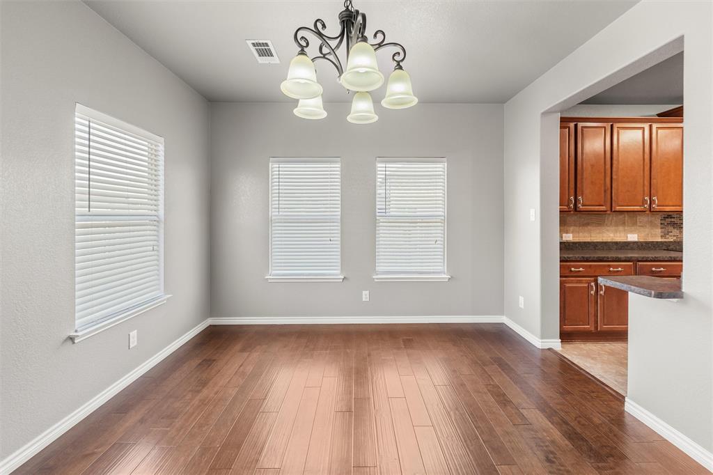 500 Braewick Drive Fort Worth, TX 76131 - Photo 15 of 35 an empty room with wooden floor and windows