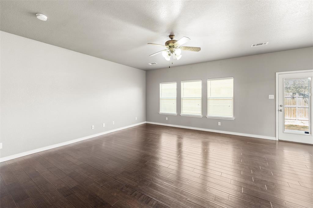 500 Braewick Drive Fort Worth, TX 76131 - Photo 17 of 35 an empty room with wooden floor and windows