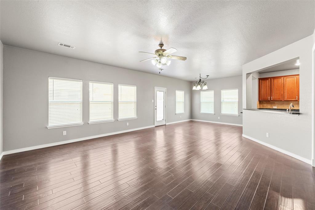 500 Braewick Drive Fort Worth, TX 76131 - Photo 18 of 35 a view of an empty room with wooden floor and a window