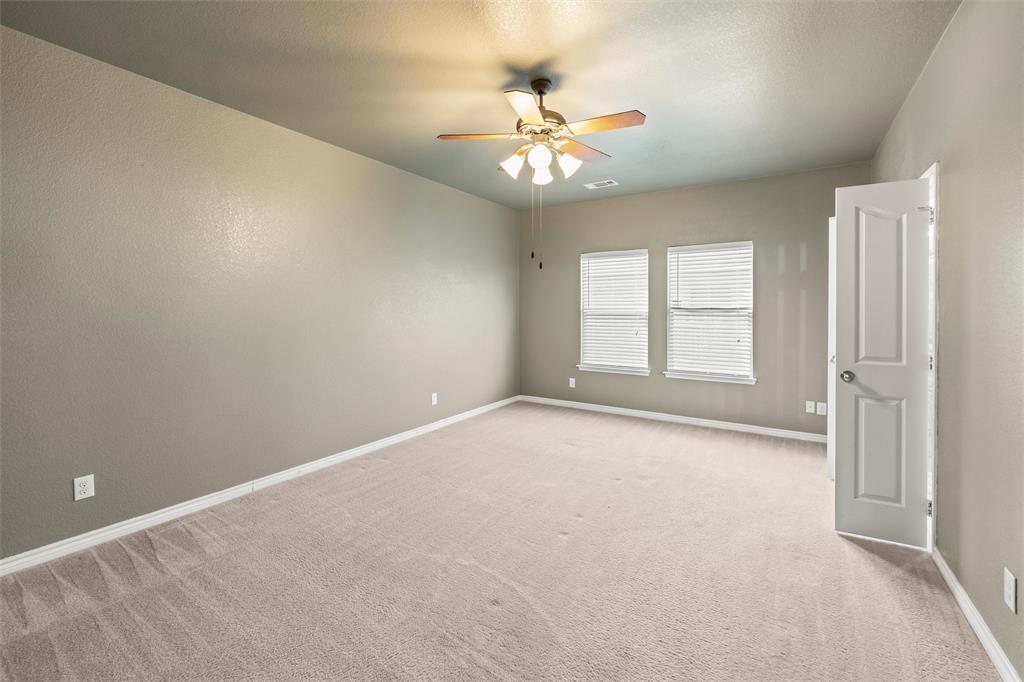 500 Braewick Drive Fort Worth, TX 76131 - Photo 19 of 35 an empty room with windows and chandelier fan