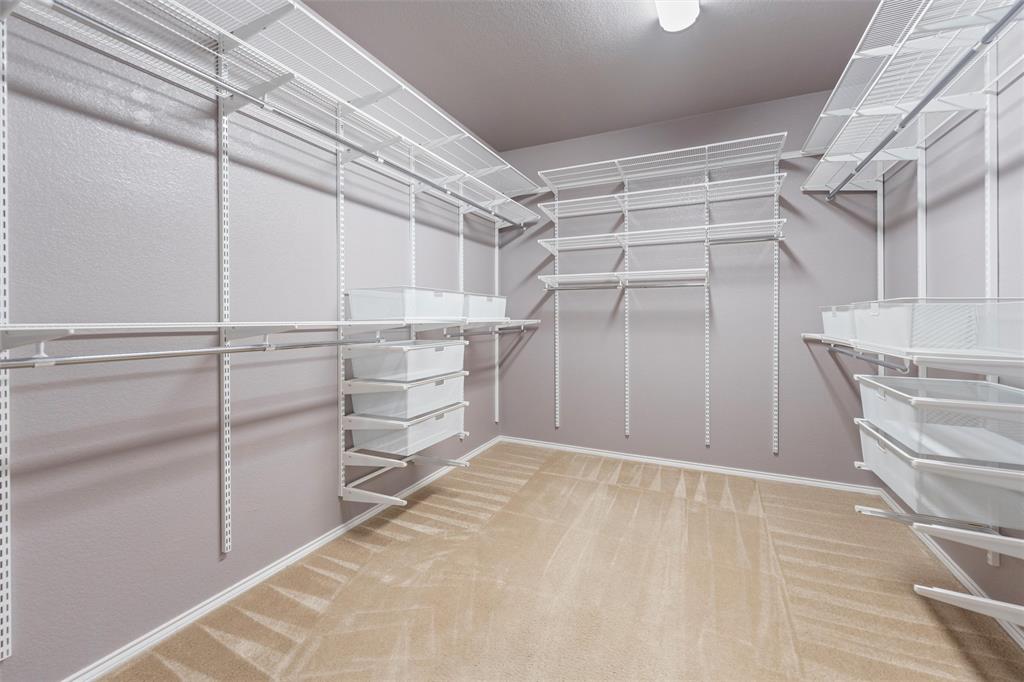 500 Braewick Drive Fort Worth, TX 76131 - Photo 23 of 35 a view of walk in closet with empty racks