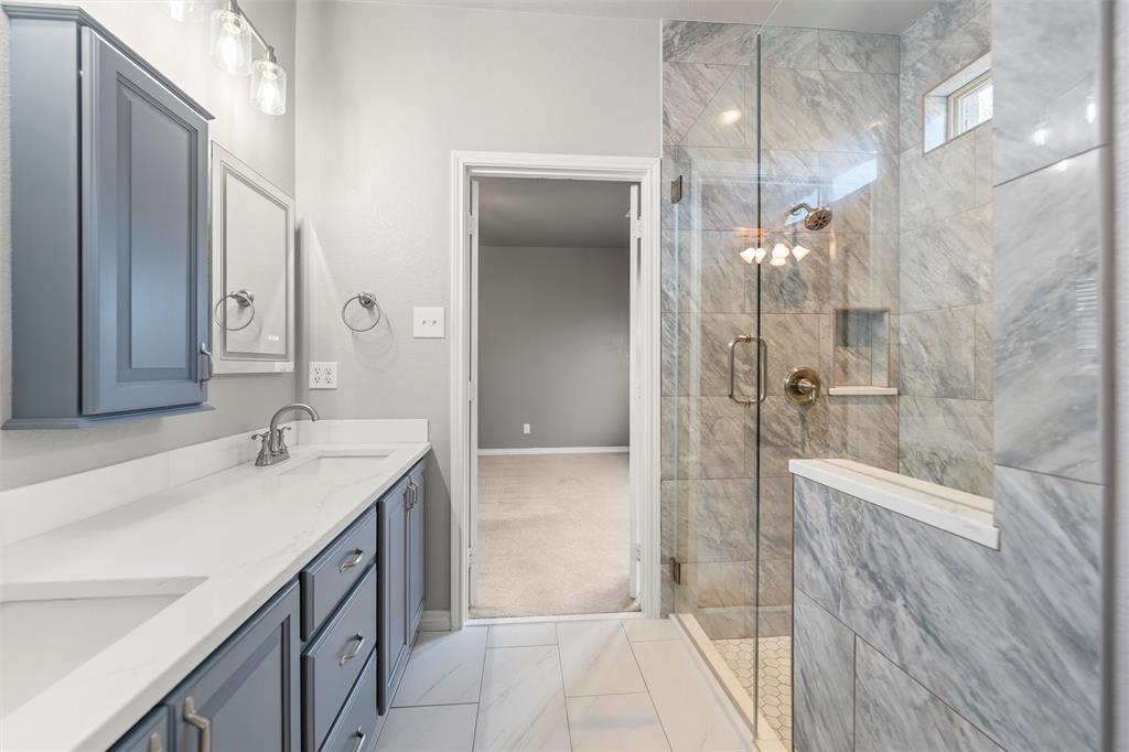 500 Braewick Drive Fort Worth, TX 76131 - Photo 24 of 35 a bathroom with a sink and a mirror