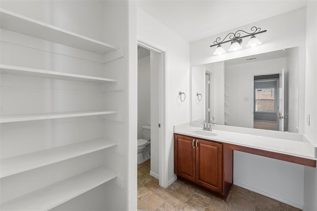 500 Braewick Drive Fort Worth, TX 76131 - Photo 28 of 35 a bathroom with a sink and a mirror