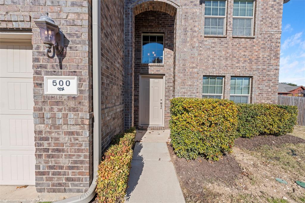 500 Braewick Drive Fort Worth, TX 76131 - Photo 4 of 35 a front view of a house with a garden