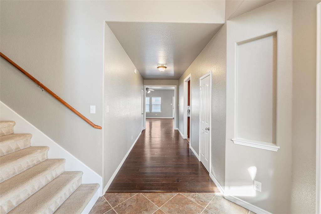 500 Braewick Drive Fort Worth, TX 76131 - Photo 8 of 35 a view of a hallway with wooden floor and staircase