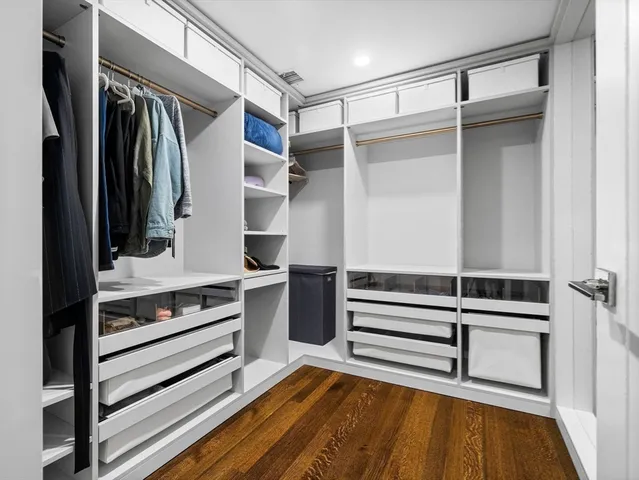 a view of walk in closet with empty racks