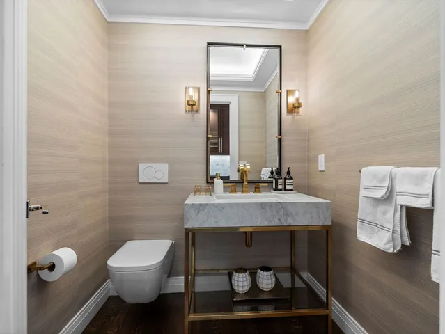 a bathroom with a toilet a sink and mirror