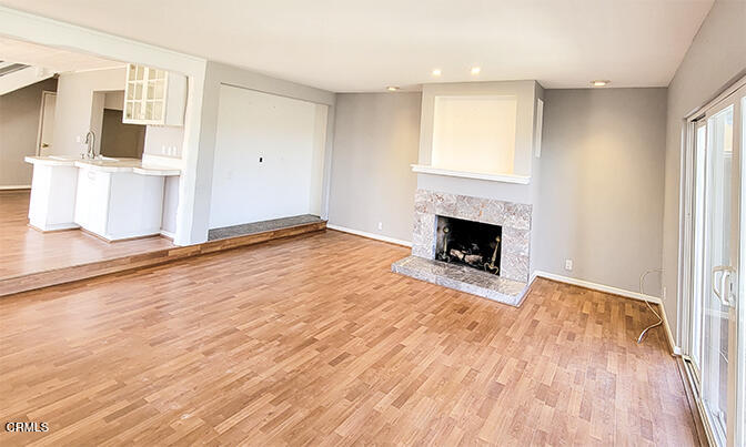 4905 Catamaran Street Oxnard, CA 93035 - Photo 4 of 14 a view of empty room with wooden floor and fireplace