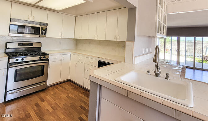 4905 Catamaran Street Oxnard, CA 93035 - Photo 6 of 14 a kitchen with a sink stove and microwave