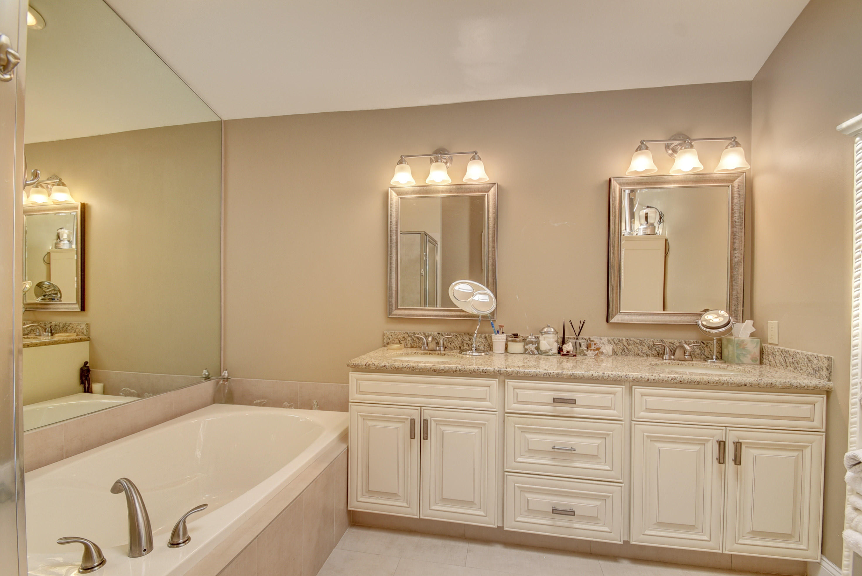 4426 Northwest 29th Way Boca Raton, FL 33434 - Photo 11 of 23 a bathroom with a double vanity sink mirror and bathtub