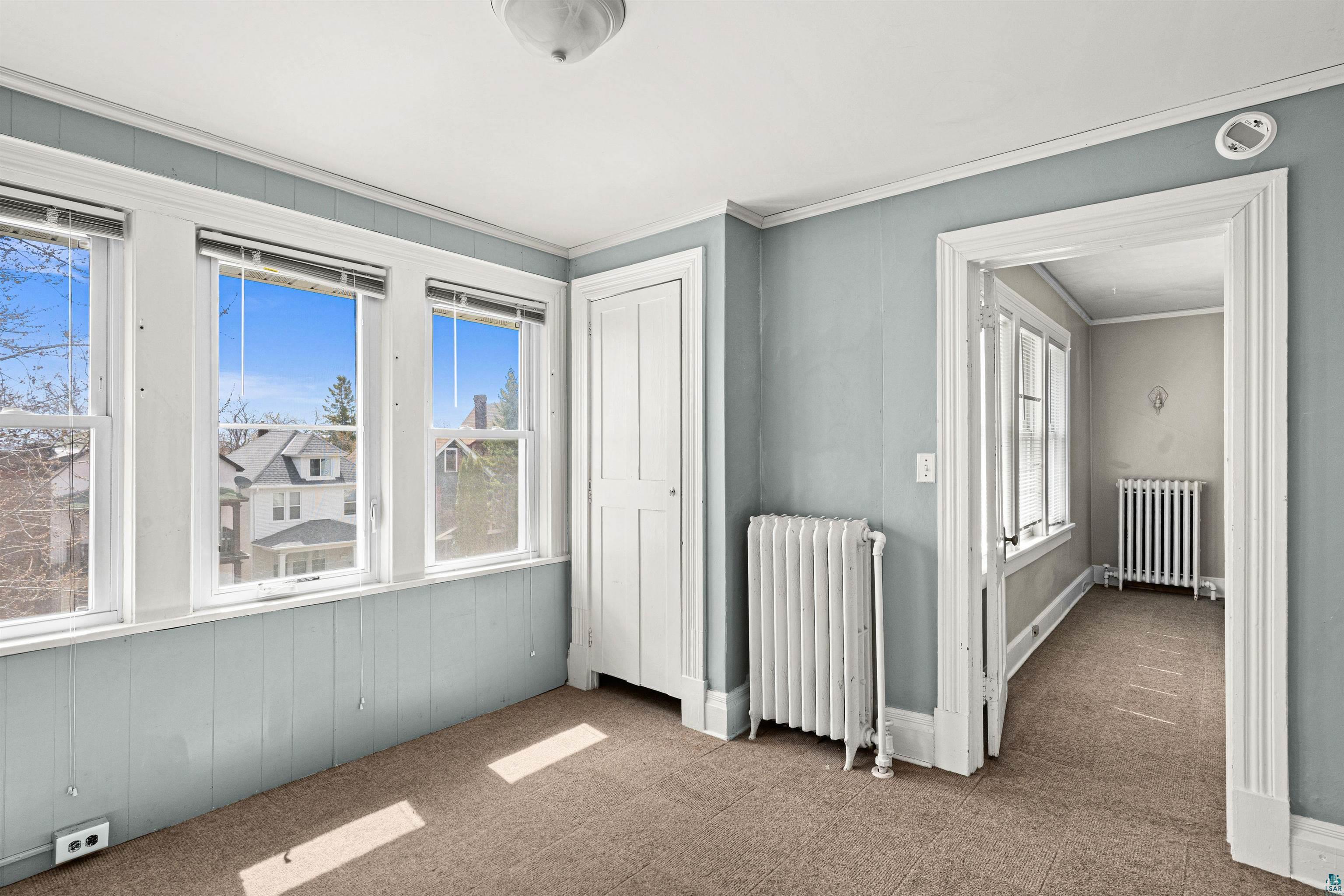 1127 East 3rd Street Duluth, MN 55805 - Photo 20 of 28 Bright room with multiple windows and a neutral carpeted floor