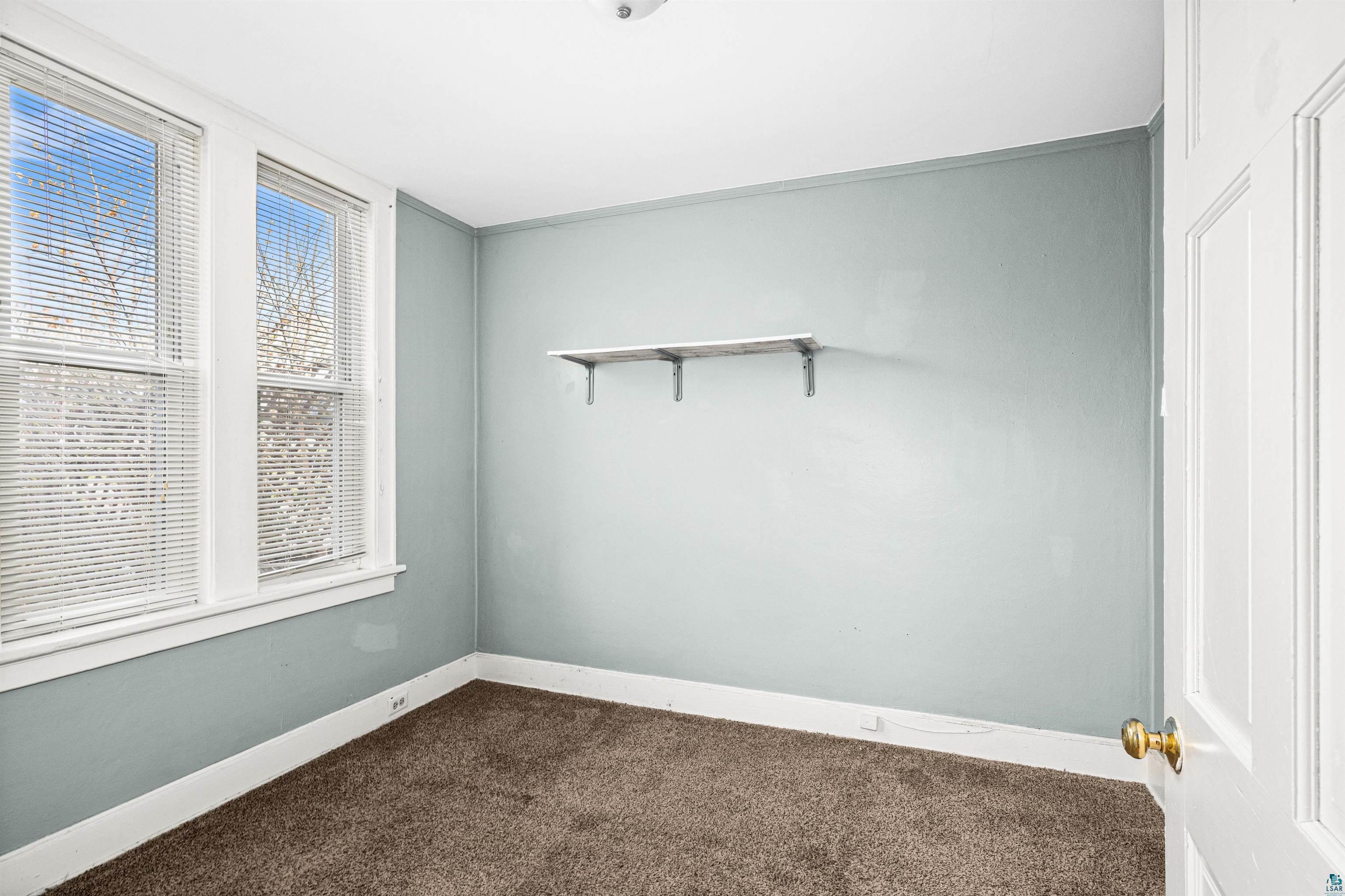 1127 East 3rd Street Duluth, MN 55805 - Photo 6 of 28 Room featuring light blue walls, brown carpet, and white trim