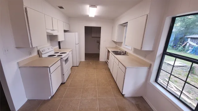 a kitchen with stainless steel appliances a sink stove and refrigerator