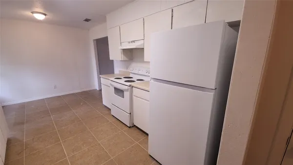 a kitchen with stainless steel appliances a refrigerator a stove a microwave and cabinets
