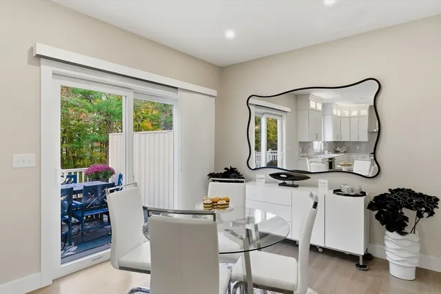 a kitchen with stainless steel appliances granite countertop a sink a stove a refrigerator and island with wooden floor