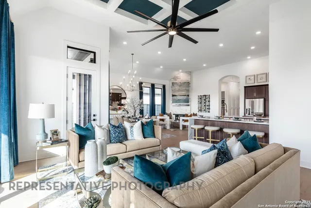 a living room with furniture and a chandelier