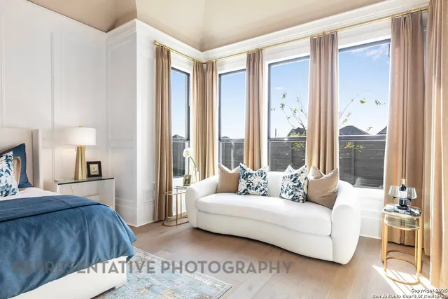 a spacious bedroom with a bed and a large window