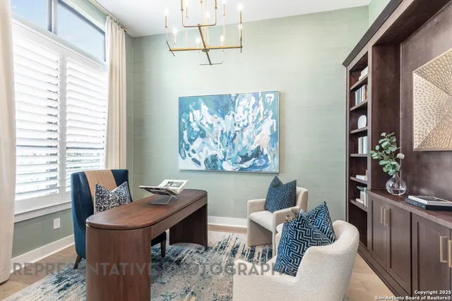 a dining room with furniture a chandelier and a window