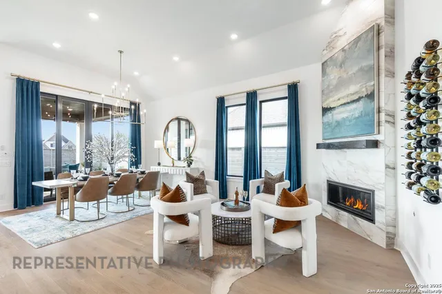 a living room with fireplace furniture and a large window