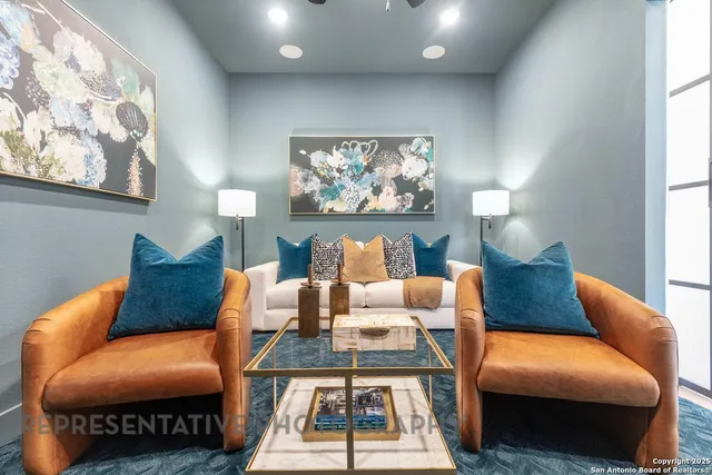 a living room with furniture a rug and a wall painting