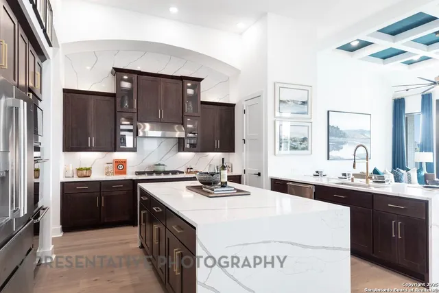 a kitchen with stainless steel appliances a sink stove and refrigerator