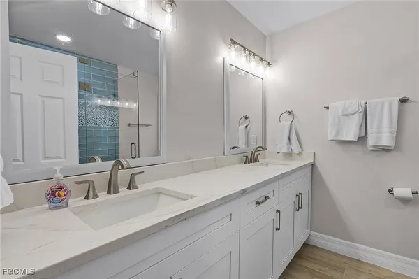 a bathroom with double vanity sinks and a mirror
