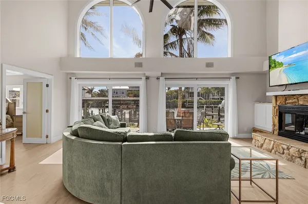 a living room with furniture a fireplace and a flat screen tv