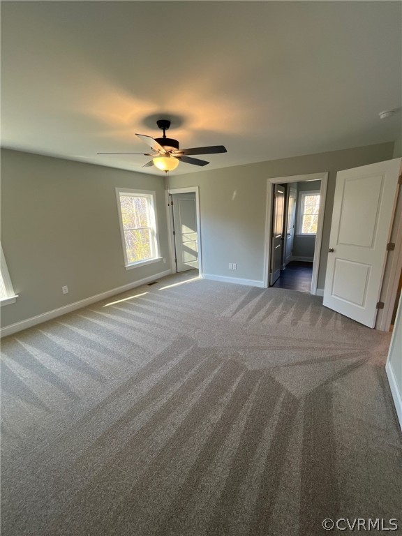 3839 Three Chopt Road Gum Spring, VA 23065 - Photo 11 of 15 an empty room with windows and ceiling fan view