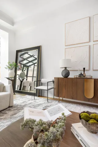 a living room with furniture or couch and a chandelier