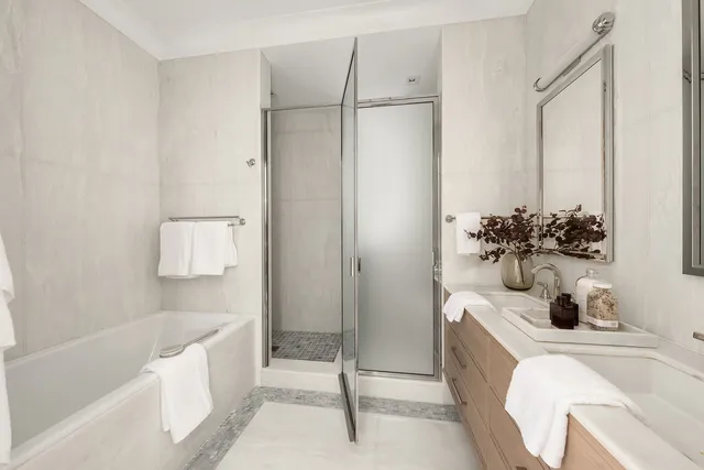 a large bed sitting in a bedroom next to a window