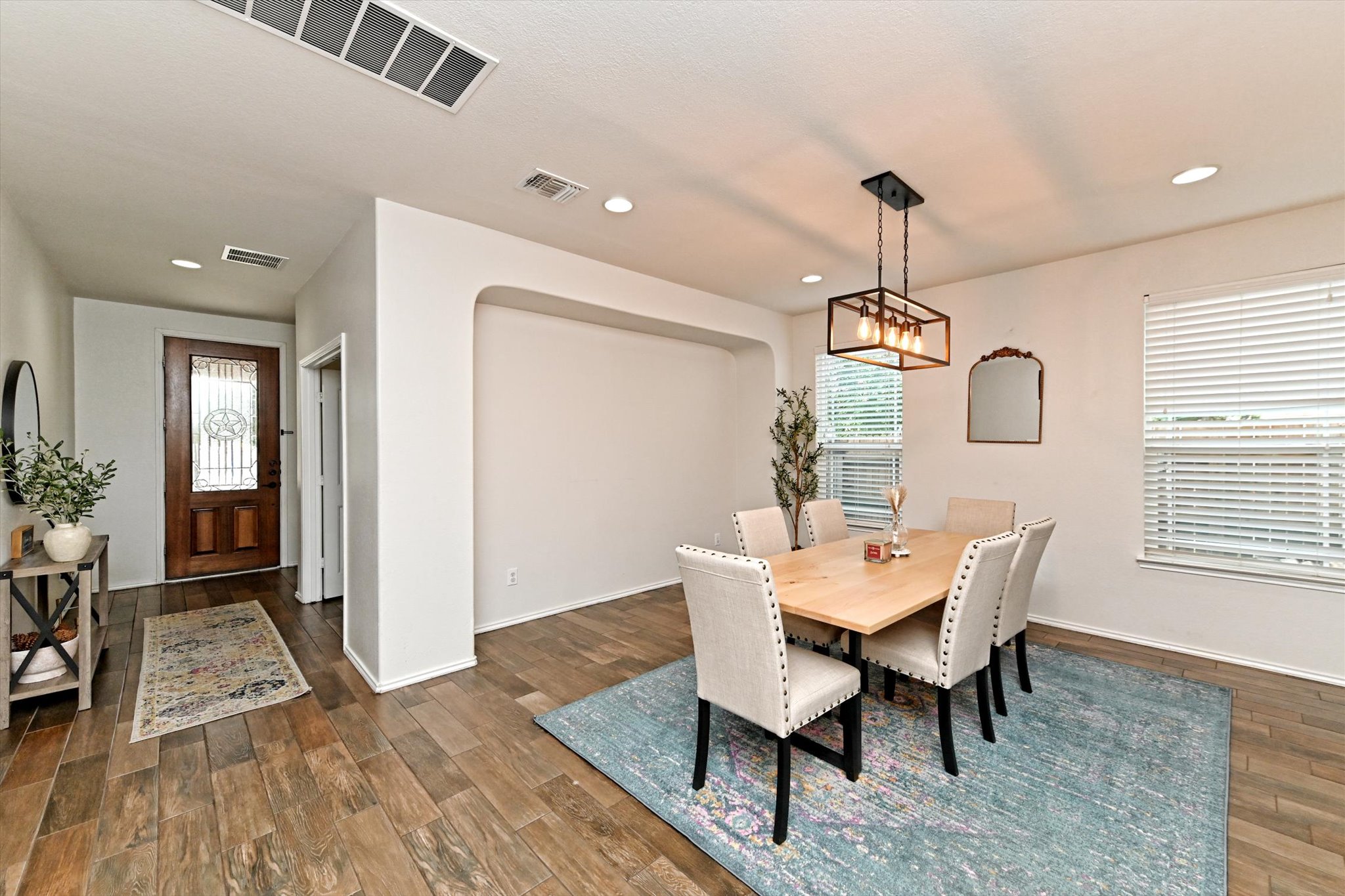 210 Animas Drive Georgetown, TX 78626 - Photo 6 of 31 a dining room with wooden floor a chandelier a wooden table and chairs