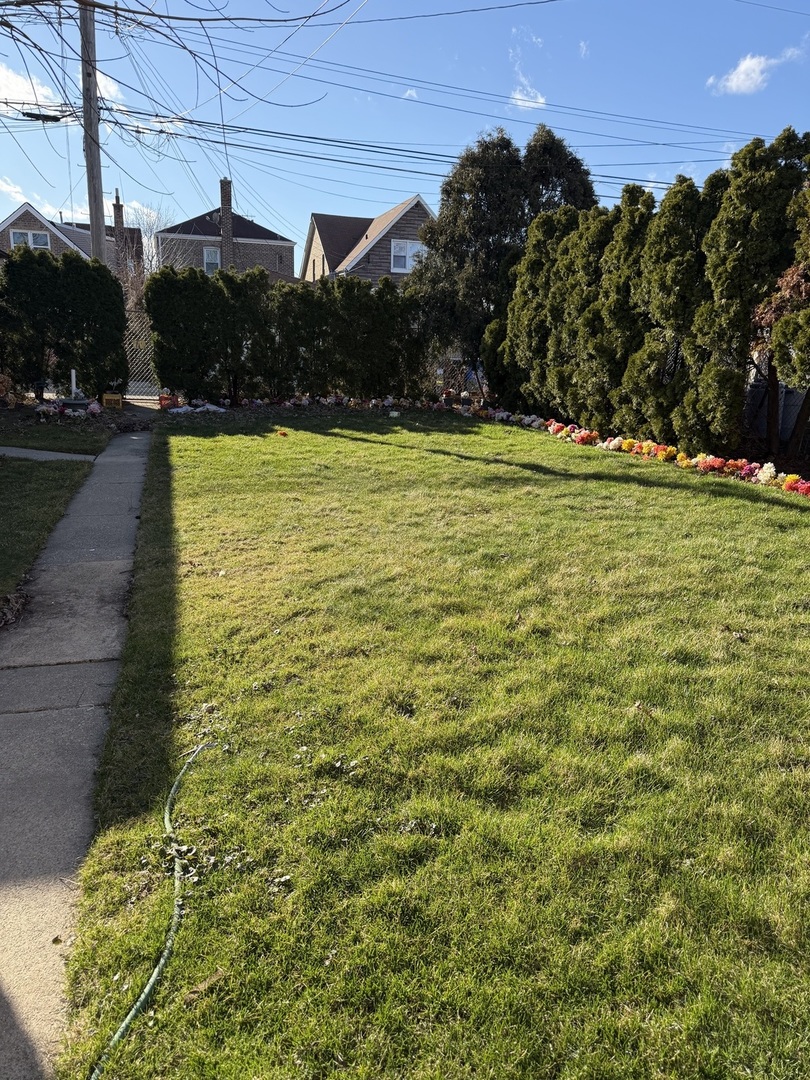10210 South Rhodes Avenue Chicago, IL 60628 - Photo 11 of 12 a view of a swimming pool with a yard