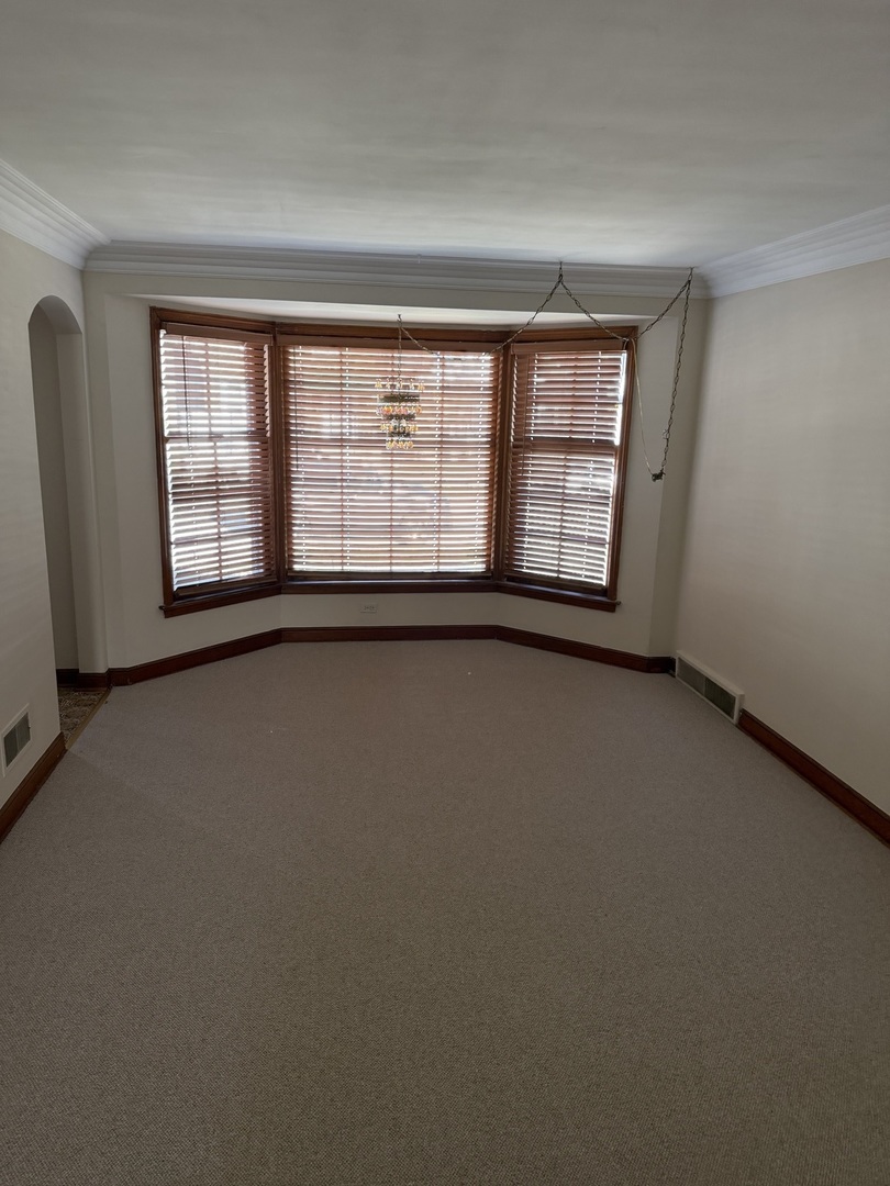 10210 South Rhodes Avenue Chicago, IL 60628 - Photo 2 of 12 an empty room with windows