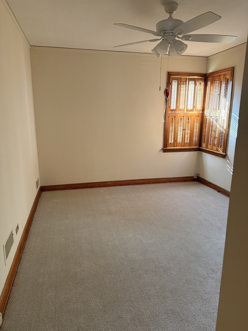 10210 South Rhodes Avenue Chicago, IL 60628 - Photo 3 of 12 a view of an empty room with a window