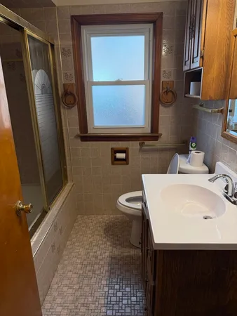 a bathroom with a sink a toilet and mirror